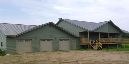 Newly finished single family home with a three-stall garage and large front porch
